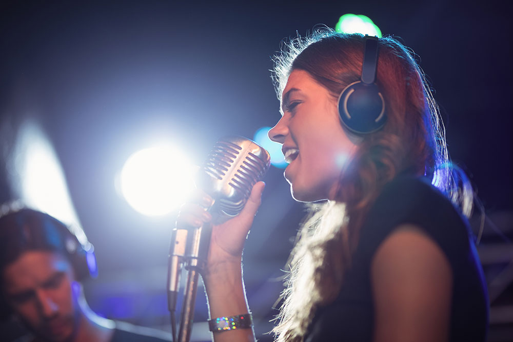female-singer-wearing-headphones-while-singing-at-2023-11-27-05-11-19-utc